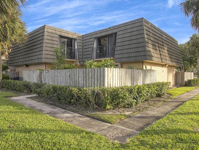 view of home's exterior with a yard and central air condition unit