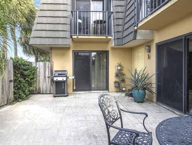 view of patio / terrace featuring a grill and a balcony