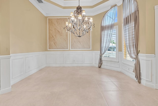 empty room with crown molding, a raised ceiling, an inviting chandelier, and light tile patterned floors