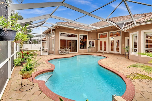 view of pool featuring french doors, a patio area, glass enclosure, and ceiling fan