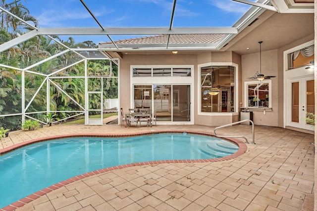 view of pool featuring ceiling fan, a patio area, and a lanai