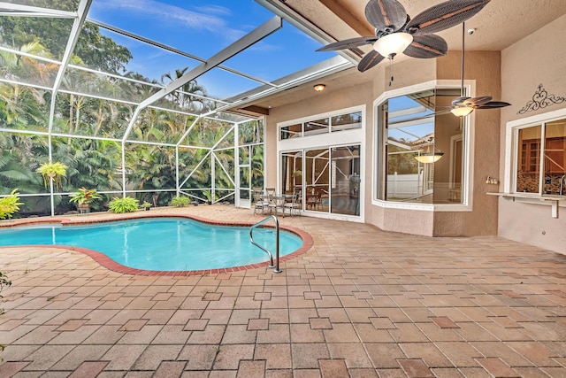 view of swimming pool with a lanai, a patio area, and ceiling fan