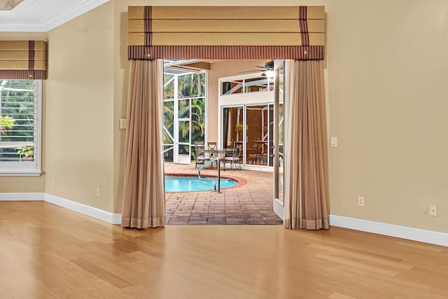 entryway featuring ornamental molding, hardwood / wood-style flooring, and ceiling fan