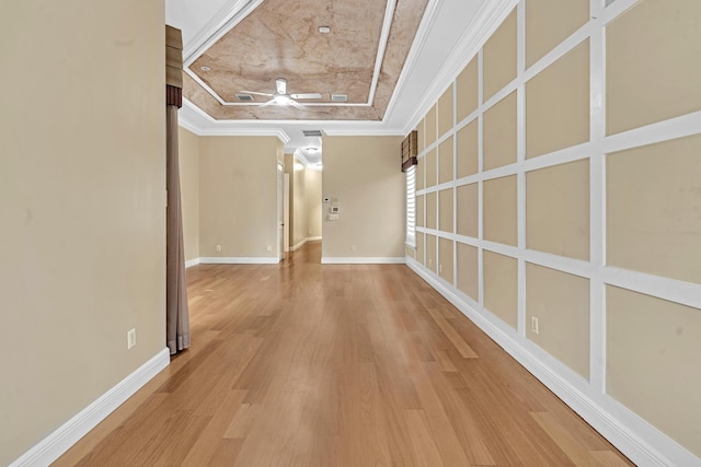 hall featuring crown molding, a raised ceiling, and wood-type flooring