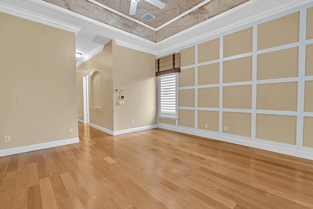 empty room with crown molding, hardwood / wood-style flooring, and ceiling fan