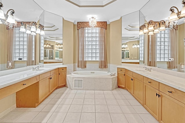 bathroom featuring vanity, tiled tub, and a raised ceiling