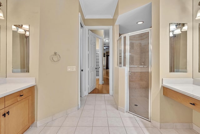 bathroom featuring vanity, crown molding, tile patterned floors, and an enclosed shower