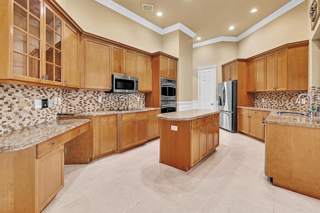 kitchen with tasteful backsplash, light tile patterned floors, stainless steel appliances, sink, and a center island