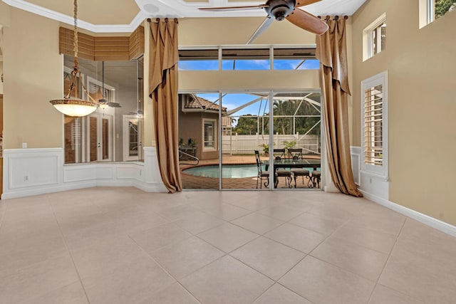 unfurnished room with crown molding, a healthy amount of sunlight, and tile patterned floors