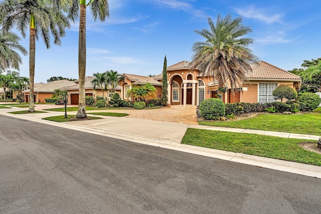 mediterranean / spanish house with a front yard