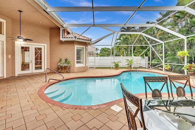 view of swimming pool featuring a patio area, a lanai, and ceiling fan