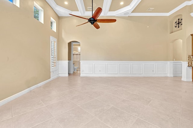 unfurnished living room with ornamental molding, light tile patterned flooring, and ceiling fan