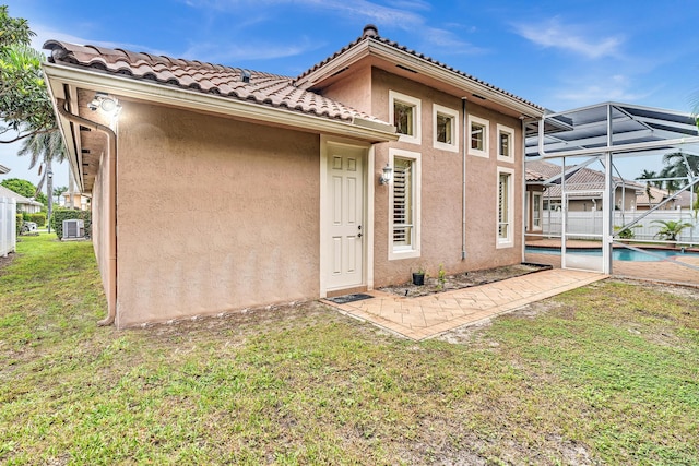 doorway to property with a yard and a patio area