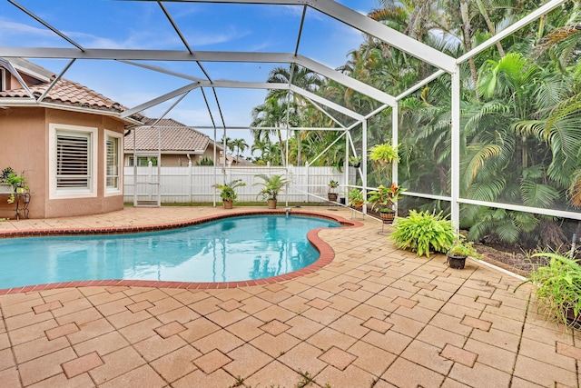 view of swimming pool with a patio and a lanai