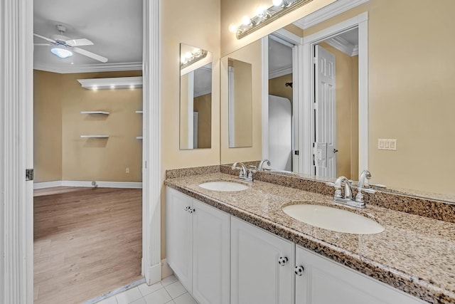 bathroom featuring vanity, crown molding, wood-type flooring, and ceiling fan