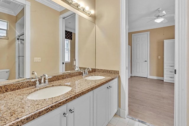 bathroom with vanity, toilet, a wealth of natural light, and hardwood / wood-style floors