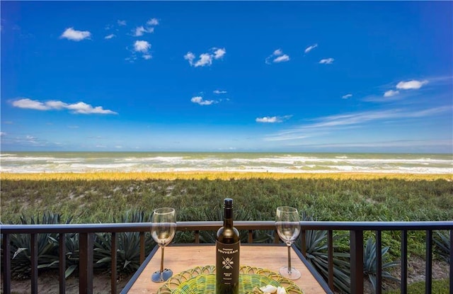 exterior space featuring a water view and a beach view