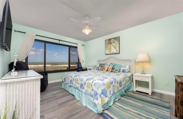 bedroom with hardwood / wood-style floors and ceiling fan