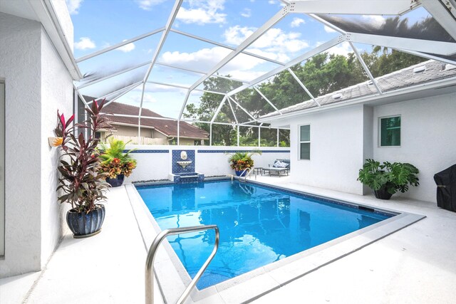 view of pool featuring a patio area, a lanai, and a fenced in pool