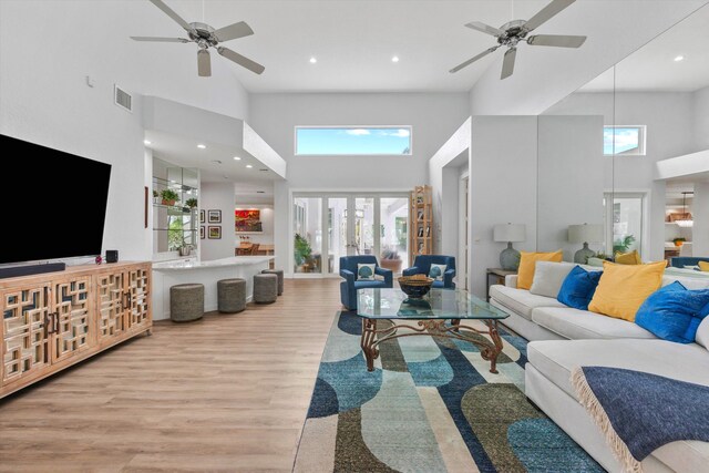 kitchen with a kitchen island, visible vents, high quality fridge, and wood finished floors