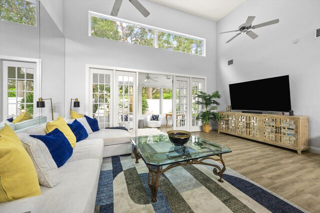 living area featuring french doors, wood finished floors, and a ceiling fan