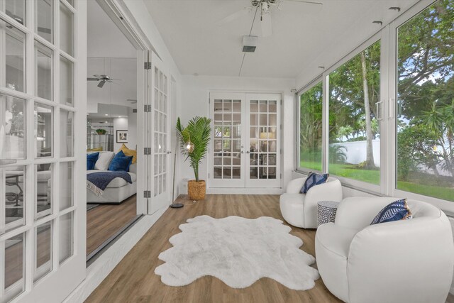 sunroom / solarium featuring a ceiling fan and french doors