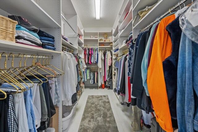 spacious closet with tile patterned floors