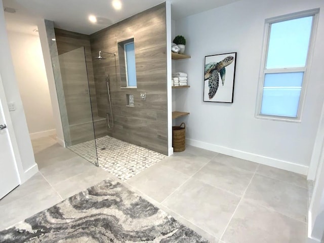 full bathroom with a walk in shower, tile patterned flooring, and baseboards