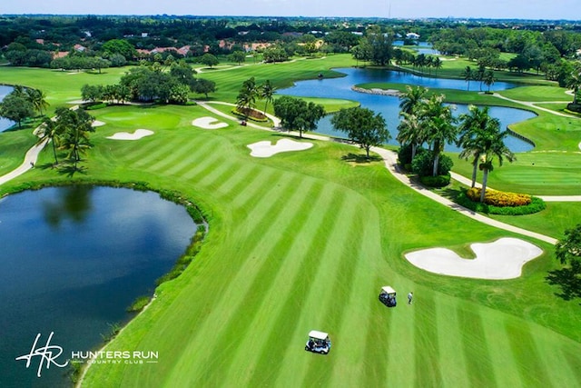 birds eye view of property featuring view of golf course and a water view