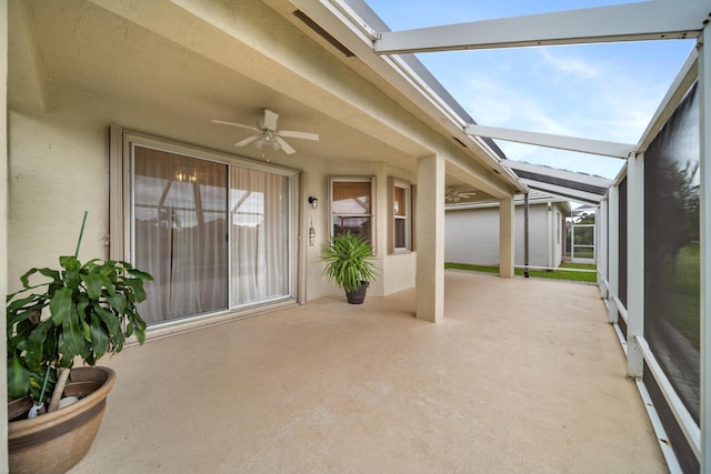 property entrance featuring a ceiling fan, a patio area, and stucco siding