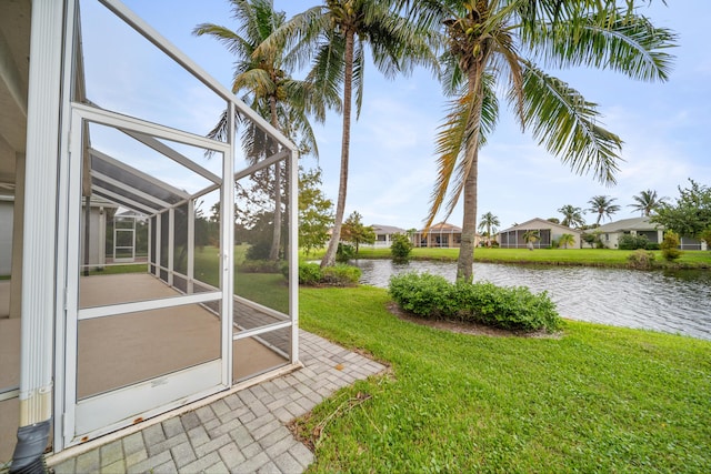 view of yard featuring a water view and a lanai