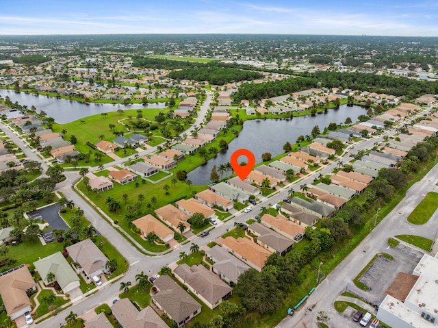 birds eye view of property featuring a water view and a residential view