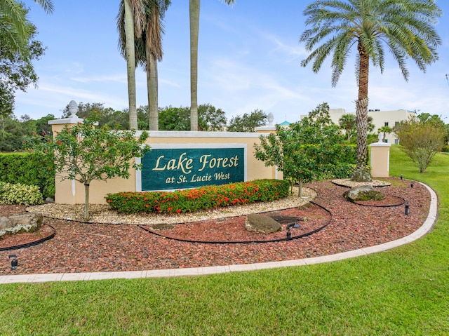 community sign featuring a lawn