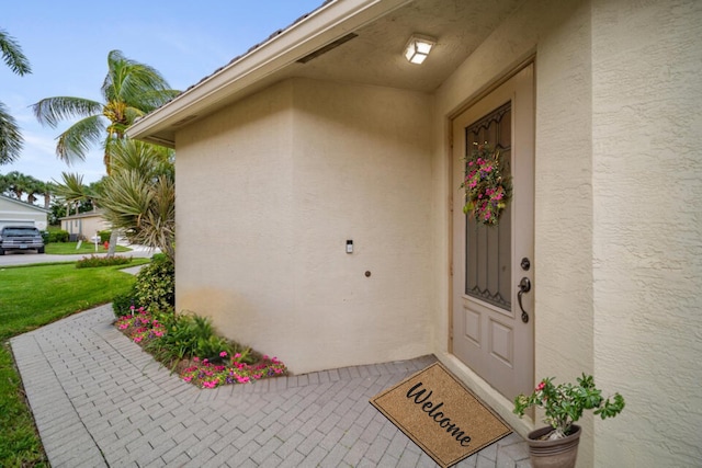 entrance to property with stucco siding