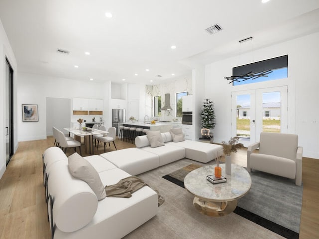 living room featuring french doors and light wood-type flooring