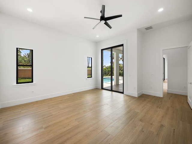 empty room featuring ceiling fan and light hardwood / wood-style flooring