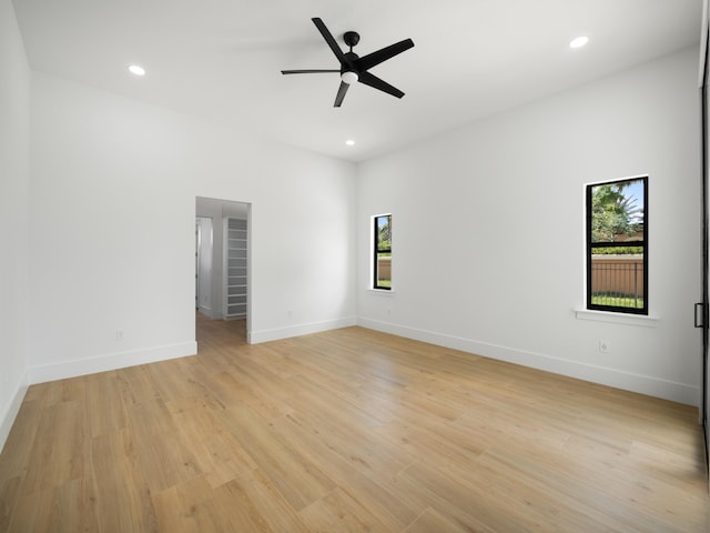 spare room with a wealth of natural light, light wood-type flooring, and ceiling fan