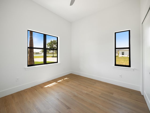 unfurnished room with light hardwood / wood-style floors and ceiling fan