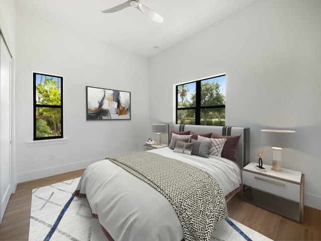 bedroom with hardwood / wood-style floors and ceiling fan