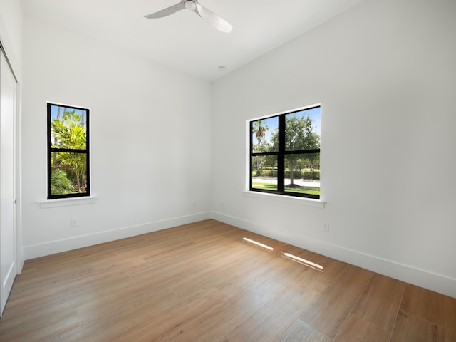 unfurnished room featuring ceiling fan, a healthy amount of sunlight, and light wood-type flooring