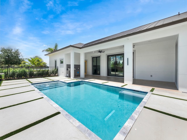 view of pool with a patio area and ceiling fan