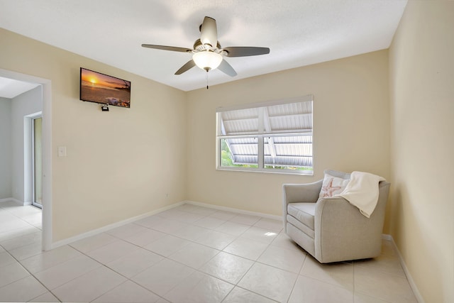 unfurnished room featuring light tile patterned floors, baseboards, and a ceiling fan
