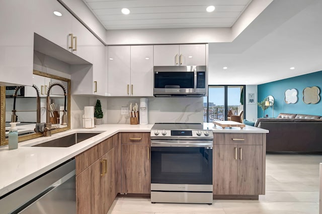 kitchen featuring white cabinetry, stainless steel appliances, and sink