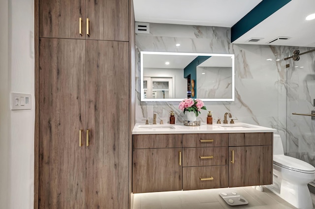 bathroom featuring toilet, decorative backsplash, a shower with shower door, and vanity