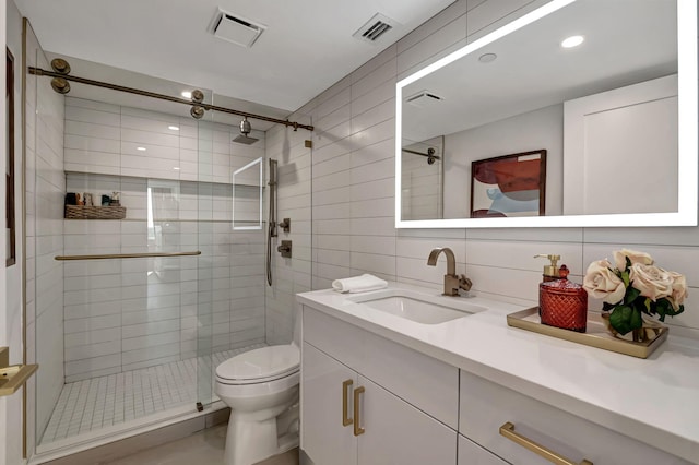 bathroom with an enclosed shower, toilet, tile walls, vanity, and decorative backsplash