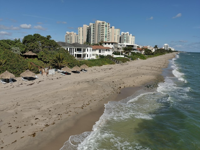 exterior space featuring a water view and a beach view