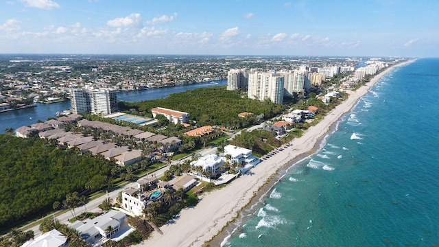 bird's eye view with a water view and a beach view