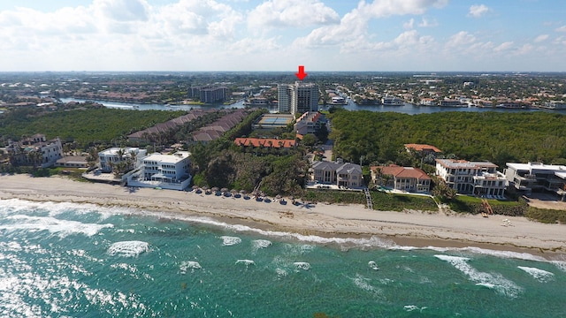 drone / aerial view featuring a water view and a view of the beach