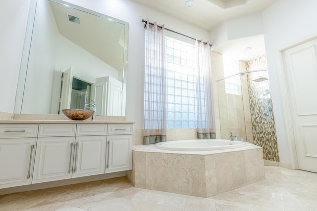 bathroom featuring vanity and separate shower and tub