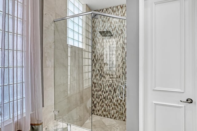 bathroom with a shower with shower door